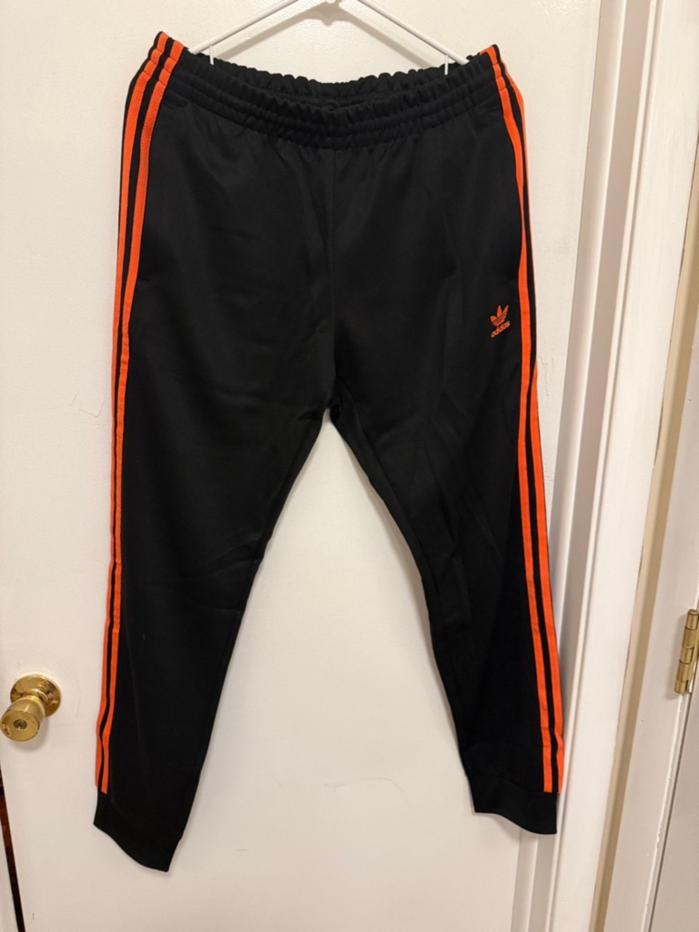 adidas originals SST Superstar Black jogger track pants with Orange Side Stripes